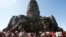 FILE - Tourists line up for stepping up Angkor Wat temple outside Siem Reap, Cambodia, Dec. 31, 2017.