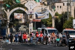 Residents of the Jenin refugee camp flee their homes as the Israeli military pressed ahead with an operation in the area, in Jenin, West Bank, July 4, 2023.