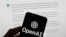 FILE - The OpenAI logo is seen on a mobile phone in front of a computer screen displaying output from ChatGPT. Experts say artificial intelligence will make investigative journalism easier, especially for smaller newsrooms.