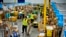FILE - Employees load packages on carts at an Amazon delivery station, July 16, 2024, in South Gate, Calif. "The economy has been very strong for a couple of years," said Kimberly Clausing of the Peterson Institute for International Economics.