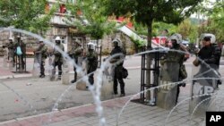 The NATO-led peacekeeping mission of KFOR soldiers stand near a barbed wire in front of the city hall in the town of Zvecan in northern Kosovo, May 31, 2023. NATO said it will send 700 more troops to northern Kosovo to help quell violent protests after the clashes on Monday.