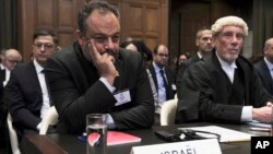 British jurist Malcolm Shaw, right, legal adviser to Israel's Foreign Ministry Tal Becker, left, looks on during the opening of the hearings at the International Court of Justice in The Hague, Netherlands, Jan. 11, 2024.