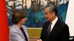 Chinese Foreign Minister Wang Yi, right, shakes hands with French Foreign Minister Catherine Colonna at the Diaoyutai State Guesthouse in Beijing, Nov. 24, 2023. 