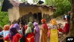 A group of Meira Paibi women of the Meitei community gather in front of the partially charred house of an alleged suspect of a viral sexual assault video in Pechi Awang Leikai village of the Thoubal district of north eastern state of Manipur, India, July 22. 2023. 