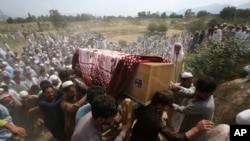 FILE - Relatives and mourners carry the casket of a victim, who was killed in a suicide bomber attack in the Bajaur district of Khyber Pakhtunkhwa, Pakistan, July 31, 2023.