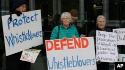 FILE - Whistleblower supporters demonstrate outside the Australian Capital Territory Supreme Court on June 27, 2019, in Canberra, Australia, where former army lawyer David McBride appeared, charged with leaking secret documents.