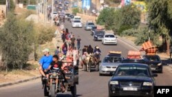 Palestinians with their belongings leave Gaza City as they flee from their homes following the Israeli army's warning, Oct. 13, 2023. 