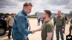 Photo by Ukrainian Presidential Press Office, Ukrainian President Volodymyr Zelenskyy, center, with Azov commander Denys Prokopenko at airport in Istanbul, Turkey, July 8, 2023.