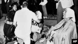 FILE - Firefighters offer first aid to survivors of a flash fire that swept through the UpStairs Lounge in New Orleans, Louisiana, in the early morning hours of June 25, 1973.