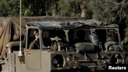 An Israeli soldier sits inside a military vehicle, near the Israel-Gaza border, in southern Israel, Jan. 15, 2024.