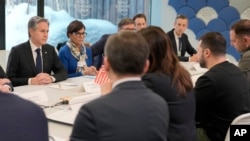 U.S. Secretary of State Antony Blinken, left, meets with Ukrainian President Volodymyr Zelenskyy, right, at the World Economic Forum in Davos, Switzerland, Jan. 16, 2024.