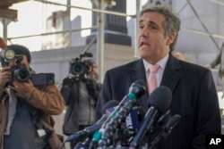 FILE - Donald Trump's former lawyer Michael Cohen speaks to reporters after a second day of testimony in New York, March 15, 2023.