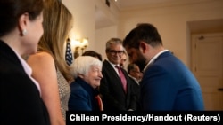 FILE - U.S. Secretary of the Treasury Janet Yellen, left, shakes hands with Chile's president Gabriel Boric, right, as Chile's Finance Minister Mario Marcel looks on during their meeting in Santiago, Chile, March 1, 2024.