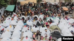 FILE — People fleeing gang violence take shelter at a sports arena in Port-au-Prince, Haiti, Sept. 1, 2023. 