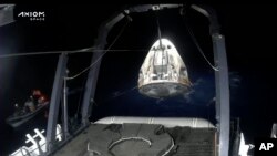 In this frame grab from video broadcast by SpaceX, recovery crews lift and secure the SpaceX Dragon capsule after it splashed down into the Gulf of Mexico, just off the Florida Panhandle, on May 30, 2023. (SpaceX via AP)