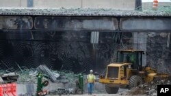 Crews continue to work the scene of a collapsed elevated section of Interstate 95 in Philadelphia, June 14, 2023. 