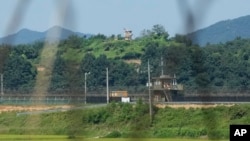 FILE - A North Korean military guard post, upper middle, and South Korean post, bottom, are seen from Paju, South Korea, near the border with North Korea, on Sept. 8, 2023.