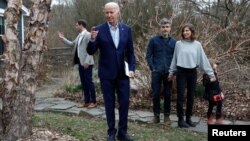 U.S. President Joe Biden crosses his fingers when asked about a cease-fire in the ongoing conflict in Gaza between Israel and Hamas, following a private campaign event in Swarthmore, Pennsylvania, March 8, 2024. 