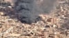FILE - An aerial view of the black smoke and flames from a market in Omdurman, Sudan, May 17, 2023.