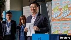 Hong Kong Chief Executive John Lee votes at a polling station during the District Council election in Hong Kong, Dec. 10, 2023.
