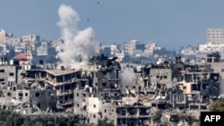 This picture taken from Israel's southern city of Sderot shows a smoke plume erupting during Israeli bombardment in the northern Gaza Strip, Oct. 19, 2023