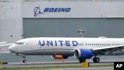 FILE - A Boeing 737 Max 9 built for United Airlines lands at King County International Airport - Boeing Field after a test flight, in Seattle, Nov. 18, 2020.