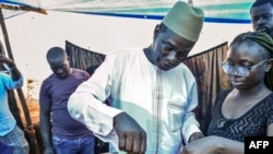 All Peoples Congress Party (APC) Presidential Candidate Samura Kamara (C) casts his ballot in Freetown on June 24, 2023