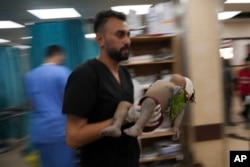 Palestinian child wounded in Israeli bombardment is brought to a hospital in Deir al Balah, south of the Gaza Strip, Nov. 2, 2023.