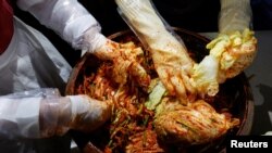 Lee Ha-yeon, a recognized kimchi grand master and her apprentices prepare kimchi at the Kimchi Culture Institute in Namyangju, South Korea, Aug. 21, 2024. 