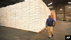 An official from the U.N. World Food Program inspects a donation of $11 million worth of food aid in Harare, Zimbabwe, Jan 17. 2024.