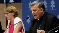 Secretary General of the Synod of Bishops Cardinal Mario Grech, right, delivers his speech during a presentation of the new guidelines for the Synod of Bishops at the Vatican, June 20, 2023.