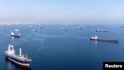 FILE: Commercial vessels, including some that are part of the Black Sea grain deal, wait to pass the Bosphorus strait off the shores of Yenikapi during a misty morning in Istanbul, Turkey, October 31, 2022