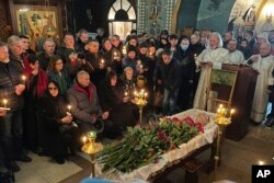 Relatives and friends pay their last respects at the coffin of Russian opposition leader Alexey Navalny in the Church of the Icon of the Mother of God Soothe My Sorrows, in Moscow, Russia, March 1, 2024.