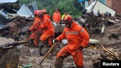 Firefighters take part in a search and rescue operation at landslide caused by torrential rain in Yecheon, South Korea, July 15, 2023. (Yonhap via Reuters)