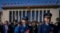 Military officers and delegates leave the Great Hall of the People after attending the second plenary session of the National People's Congress (NPC) in Beijing, March 8, 2024.
