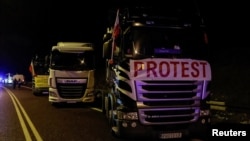 Polish trucks are parked as they block crossings at the Ukrainian border near the village of Hrebenne, Poland, Nov. 19, 2023.