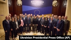 Ukrainian President Volodymyr Zelenskyy, center, poses for a photo with participants of an informal EU Foreign Ministers meeting in Kyiv, Oct. 2, 2023.