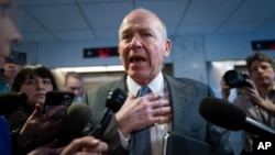 Boeing CEO Dave Calhoun speaks briefly with reporters after a meeting in the office of Sen. Mark Warner, D-Va., at the Capitol in Washington, Jan. 24, 2024.