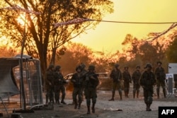 Israeli soldiers patrol near Kibbutz Beeri on October 12, 2023, where 270 revelers were killed by Hamas militants during the Supernova music festival on October 7. (Aris Messinis/AFP)