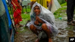 A woman whose family members are trapped under rubble wails after a landslide washed away houses in Raigad district, western Maharashtra state, India, July 20, 2023. 
