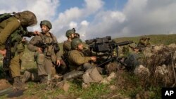 FILE — Israeli combat reservists and tank forces take part in training drills on the Lebanese front in the Israeli-controlled Golan Heights, Jan. 4, 2024.