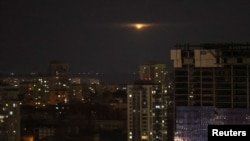 An explosion of a drone is seen in the sky over the city during a Russian drone strike, amid Russia's attacks on Ukraine, in Kyiv, Nov. 19, 2023. 