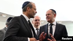 German Chancellor Olaf Scholz talks to Government Commissioner for Anti-Semitism Felix Klein during the inauguration of the newly built synagogue in Dessau Rosslau, Oct. 22, 2023. (Hendrik Schmidt/Pool via Reuters)