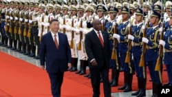 In this photo released by Xinhua News Agency, Chinese President Xi Jinping, left, and visiting South African President Cyril Ramaphosa, right, review an honor guard during a welcoming ceremony at the Great Hall of the People in Beijing, Sept. 2, 2024.