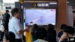 FILE - A TV screen shows a file image of a North Korean missile launch during a news program at the Seoul Railway Station in Seoul, South Korea, July 22, 2023.