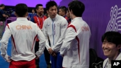 Chinese athletes congratulate Taiwan's Lee Chih Kai after he won the artistic gymnastics pommel horse final during the 19th Asian Games in Hangzhou, China, Sept. 28, 2023.