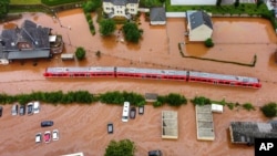 A regional train sits in the flood waters at the local station in Kordel, Germany, July 15, 2021, after it was flooded by the Kyll river. 