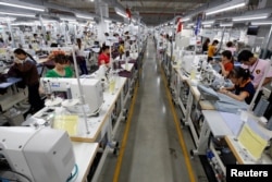 FILE - Laborers work at TAL garment factory in Vinh Phuc province, Vietnam, May 23, 2017.