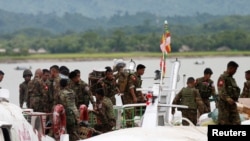 FILE - Myanmar soldiers arrive at Buthidaung, Myanmar, Aug. 29, 2017.