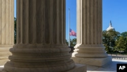The Supreme Court, with the Capitol in the background, is seen in Washington, Oct. 7, 2020. 